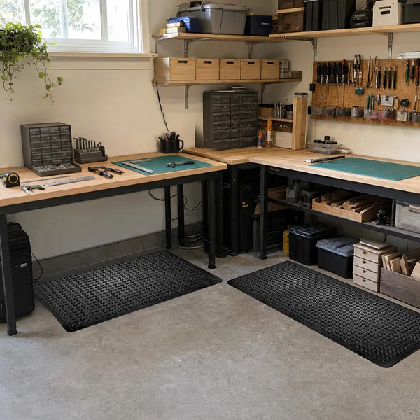 Home garage converted into multi-purpose workshop with matting zones. Organised garage workshop featuring anti-fatigue matting in key standing areas.