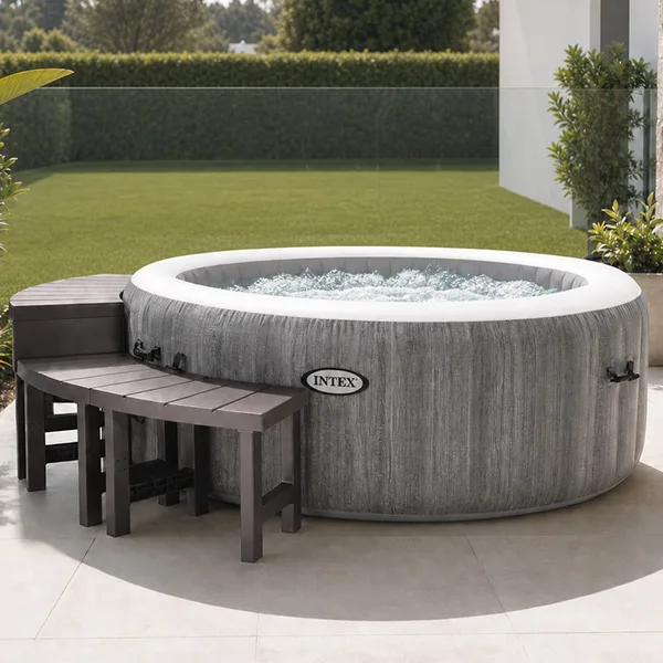 Backyard showing an inflatable spa with benches, tray, towels and potted plants. Inflatable spa relaxation zone using accessories instead of permanent landscaping.