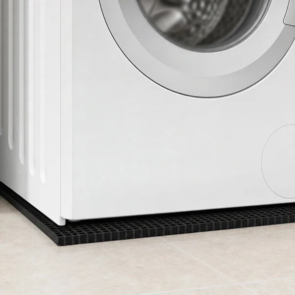 Close-up of anti-vibration pad underneath a washing machine. Rubber anti-vibration pad positioned underneath a household washing machine.
