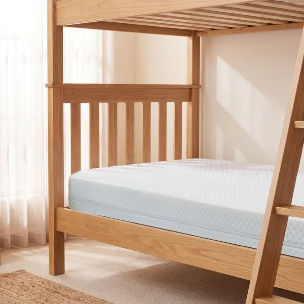 Bunk bed with a fresh single mattress in a neat bedroom setup.