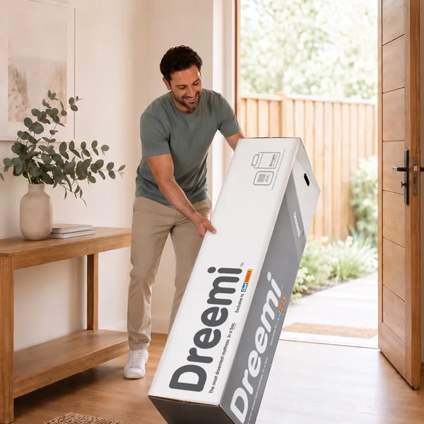 Somone moving a Dreemi mattresses still in the box.