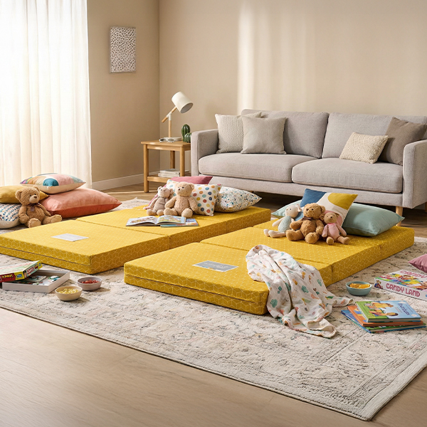 Foldable mattress set up in a living room for overnight guests