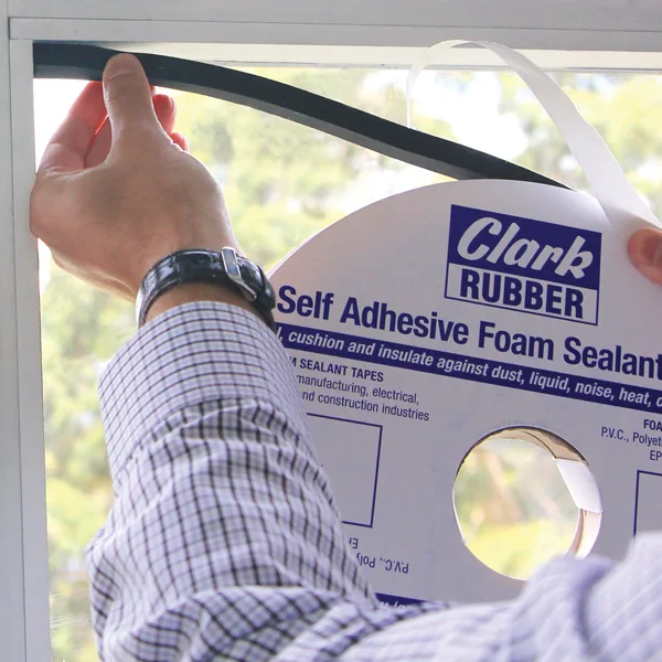 Close-up of adhesive foam tape applied along a window frame.