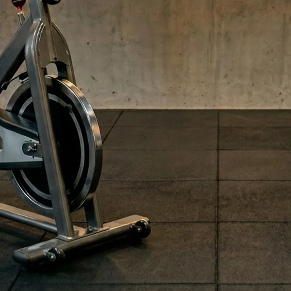 Home gym setup with black rubber gym tiles installed on the floor