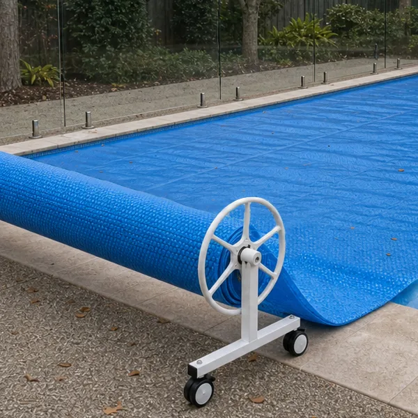 Swimming pool prepared for winter with fitted pool cover and clean outdoor area