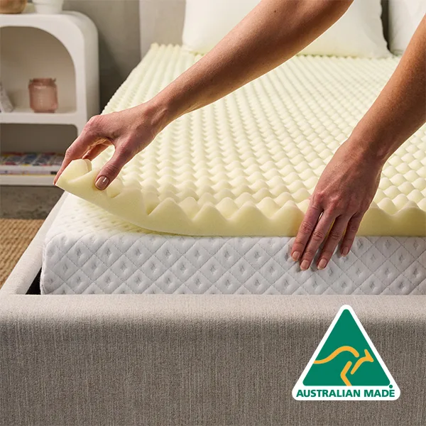 Mattress topper layered on a bed for added comfort
