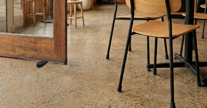 Image of a café with chair tips and table wedges being used